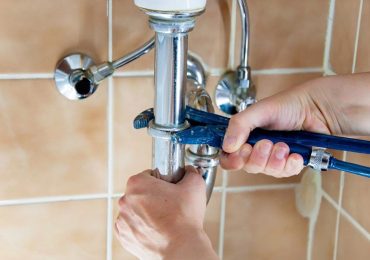 plumber repairing the bathroom plumbing in a missouri home