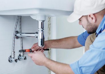 plumber repairing the bathroom sink plumbing in an missouri home